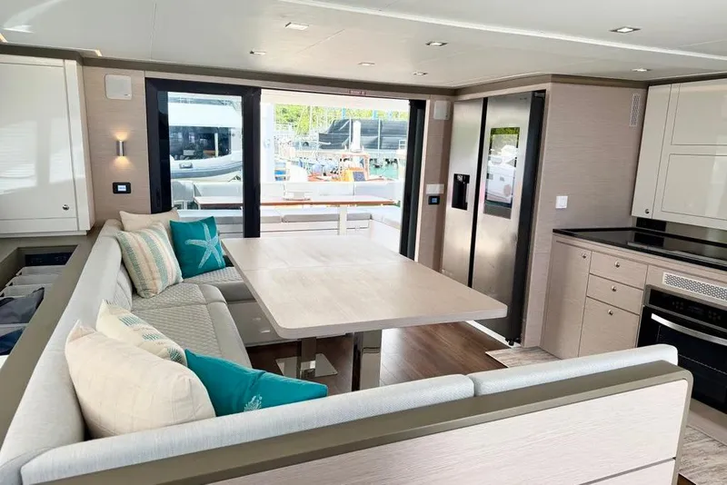 Slide: The Image of Luxurious interior of 2026 Aventura 56 Motor Yacht with modern dining area and kitchen. - 13