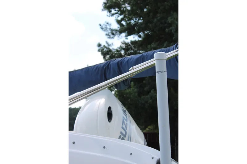 Slide: The Image of 2020 Hurricane SunDeck 187 OB boat with Suzuki outboard motor and blue canopy. - 17