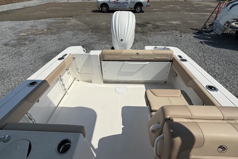 Slide: The Image of The image shows the cockpit of a 2025 Edgewater 248CX Crossover with beige seating. - 8