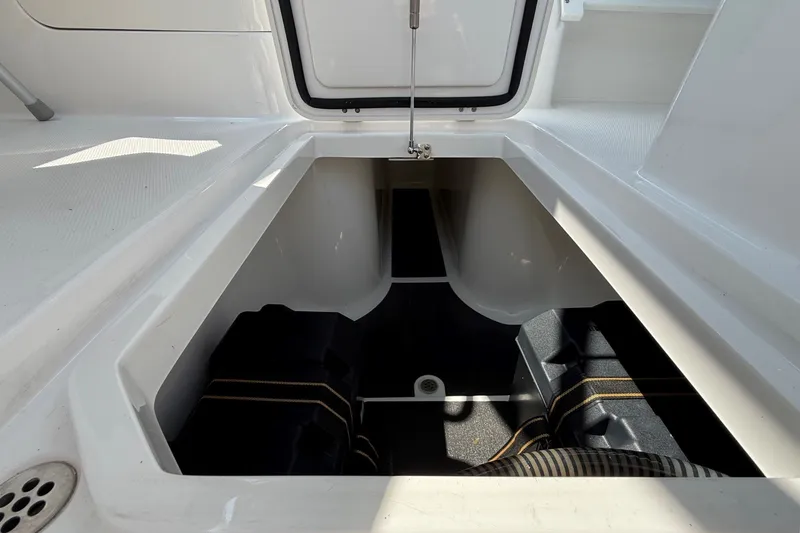 Slide: The Image of Open storage compartment on 2025 Edgewater 248CX Crossover boat, showcasing interior space. - 14