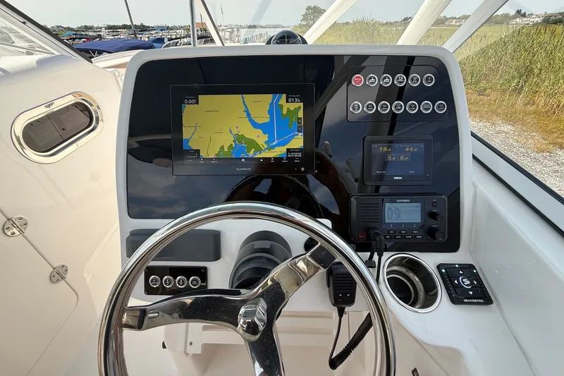 Slide: The Image of Helm of 2025 Edgewater 248CX Crossover with navigation display and controls. - 20