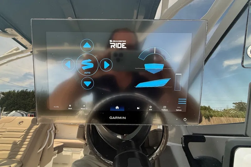 Slide: The Image of Touchscreen display on 2025 Edgewater 248CX Crossover boat, featuring Seakeeper Ride system. - 23