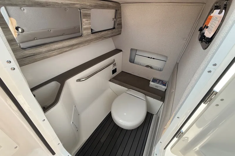 Slide: The Image of 2025 Edgewater 248CX Crossover boat bathroom with modern amenities and sleek design. - 19