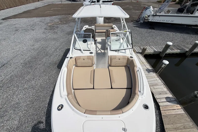 Slide: The Image of 2025 Edgewater 248CX Crossover boat with spacious seating, docked at a marina. - 30