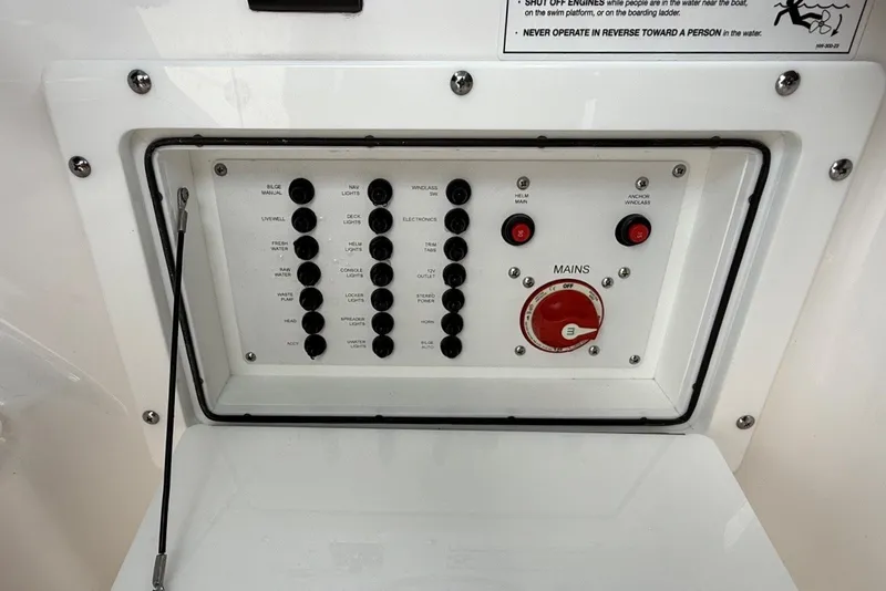 Slide: The Image of Control panel of 2025 Edgewater 248CX Crossover boat with switches and main power dial. - 26