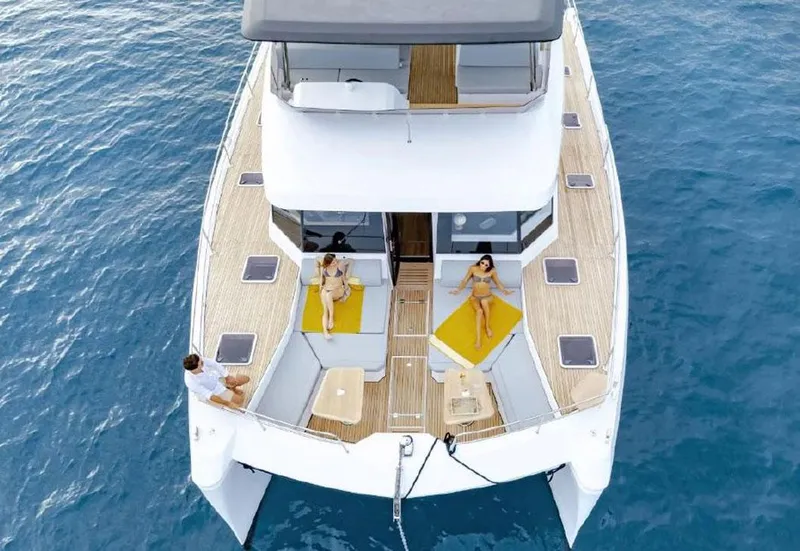 Slide: The Image of Aventura 56 Motor Yacht 2025 on blue ocean, featuring spacious deck and lounging area. - 1