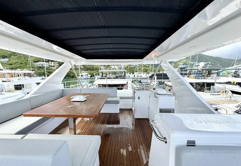 Slide: The Image of Luxurious 2025 Aventura 56 Motor Yacht deck with seating and dining area. - 11