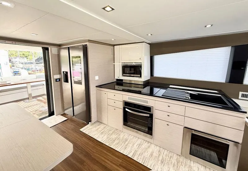 Slide: The Image of Modern kitchen interior of 2025 Aventura 56 Motor Yacht with sleek appliances and wood flooring. - 7