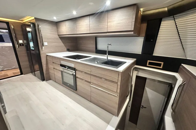 Slide: The Image of Modern kitchen interior of 2026 Aventura 56 Motor Yacht with sleek wood cabinetry. - 16
