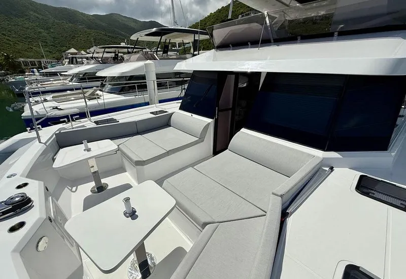Slide: The Image of 2025 Aventura 56 Motor Yacht with sleek seating and modern design in a marina setting. - 13