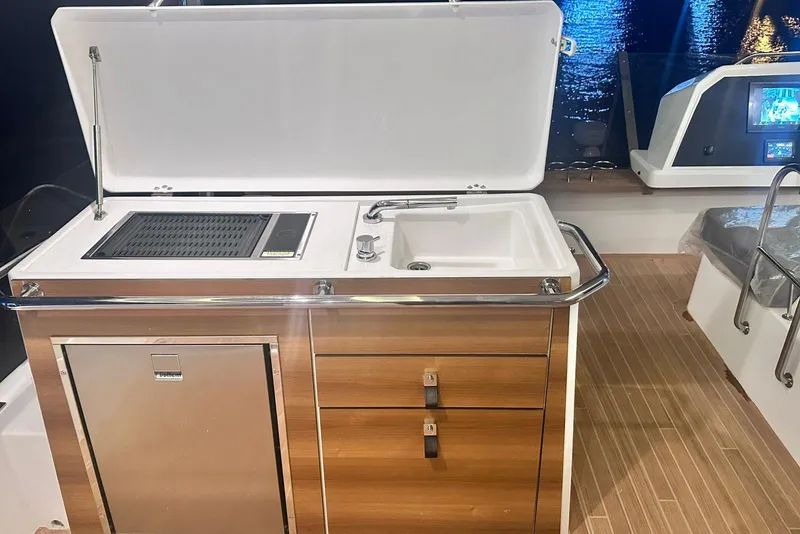 Slide: The Image of Outdoor kitchen on 2026 Aventura 56 Motor Yacht with sink, grill, and storage. - 6
