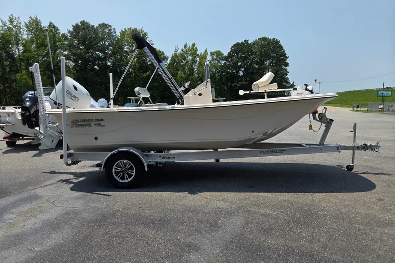 Slide: The Image of 2024 Carolina Skiff 19 LS boat on trailer, parked outdoors. - 5