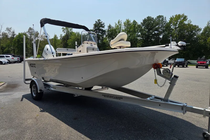 Slide: The Image of 2024 Carolina Skiff 19 LS boat on trailer in parking lot, side view. - 6