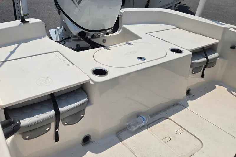 Slide: The Image of The image shows the cockpit of a 2024 Carolina Skiff 19 LS boat with storage and cup holders. - 10