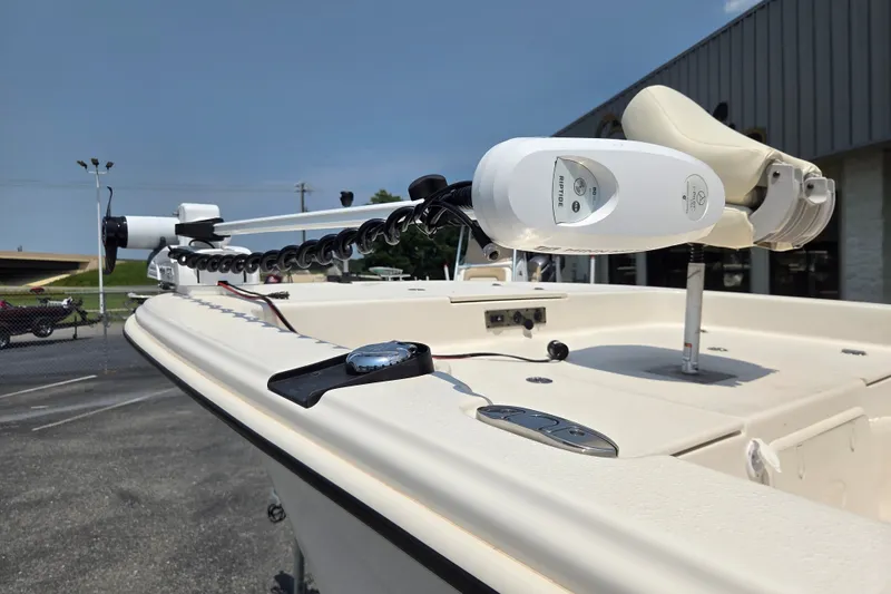 Slide: The Image of 2024 Carolina Skiff 19 LS boat with trolling motor on deck, parked outdoors. - 8
