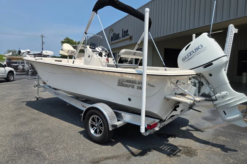 Slide: The Image of 2024 Carolina Skiff 19 LS boat with Suzuki outboard motor on trailer. - 2