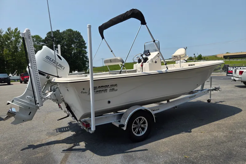Slide: The Image of 2024 Carolina Skiff 19 LS boat on trailer with Suzuki outboard motor. - 4