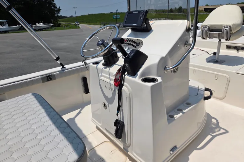 Slide: The Image of 2024 Carolina Skiff 19 LS boat console with steering wheel and navigation equipment. - 11