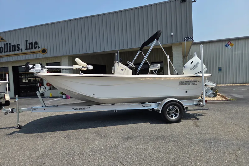 The Image of 2024 Carolina Skiff 19 LS boat on trailer outside dealership. - 0