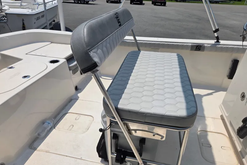 Slide: The Image of 2024 Carolina Skiff 19 LS boat interior with cushioned seating and storage compartments. - 9