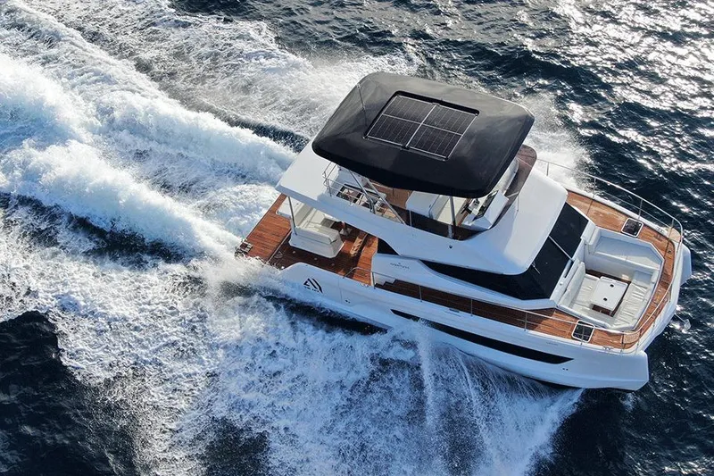 Slide: The Image of 2026 Aventura 38 Motor Yacht cruising on open water, featuring sleek design and solar panels. - 7
