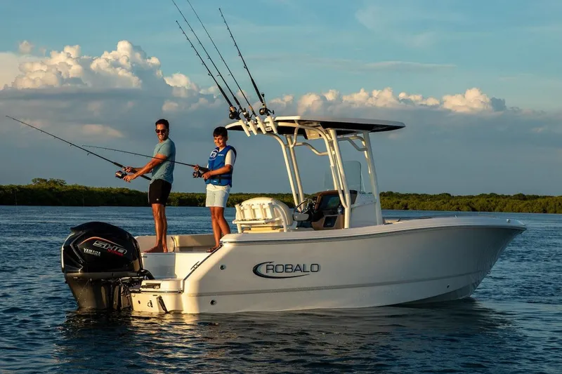 Slide: The Image of Manufacturer Provided Image: Two people fishing on a 2026 Robalo R232 Explorer boat in calm waters. - 3