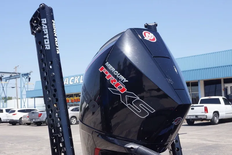 Slide: The Image of Outboard motor on Phoenix 921 Elite X, 2027 model, with Minn Kota Raptor in parking lot. - 14