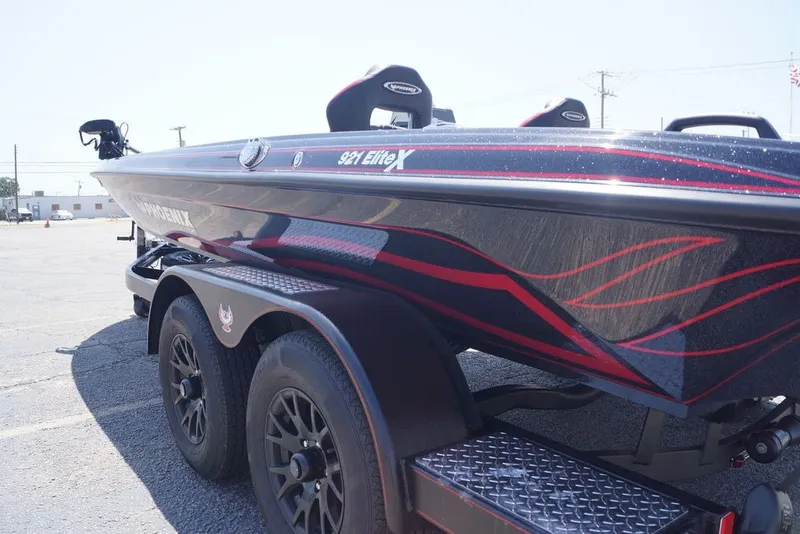 Slide: The Image of 2027 Phoenix 921 Elite X boat with sleek design and red accents on a trailer. - 16