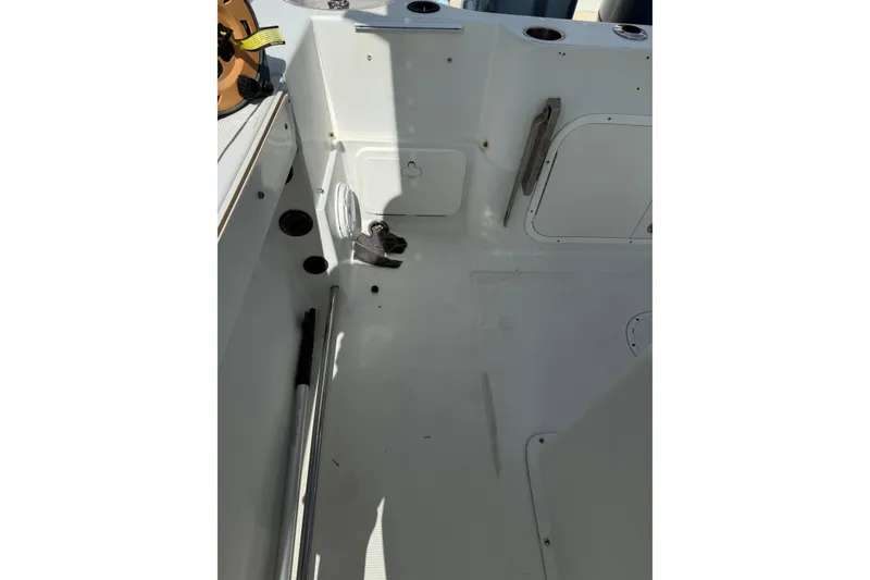 Slide: The Image of 2006 Sailfish 2360 CC boat interior with storage compartments and fishing rod holder. - 12