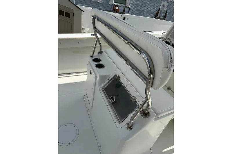 Slide: The Image of 2006 Sailfish 2360 CC boat interior with seating and storage compartment. - 10
