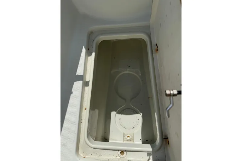 Slide: The Image of Open storage compartment on a 2006 Sailfish 2360 CC boat. - 7