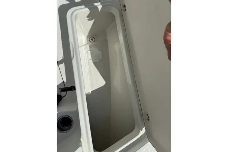 Slide: The Image of Open storage compartment on a 2006 Sailfish 2360 CC boat, showing interior details. - 6