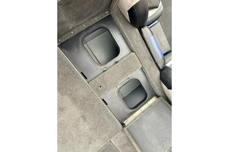 Slide: The Image of 2014 Skeeter TZX195 boat interior storage compartments and seating area. - 13