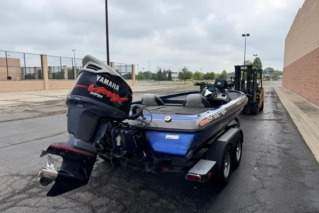 Slide: The Image of 2014 Skeeter TZX195 boat with Yamaha engine on a trailer in a parking lot. - 4
