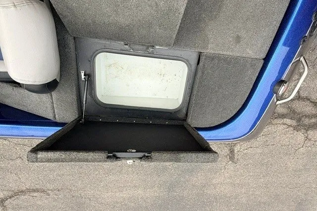 Slide: The Image of 2014 Skeeter TZX195 boat storage compartment with open hatch, showing interior space. - 12