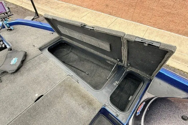 Slide: The Image of 2014 Skeeter TZX195 boat storage compartment with open lid, showcasing interior space. - 16