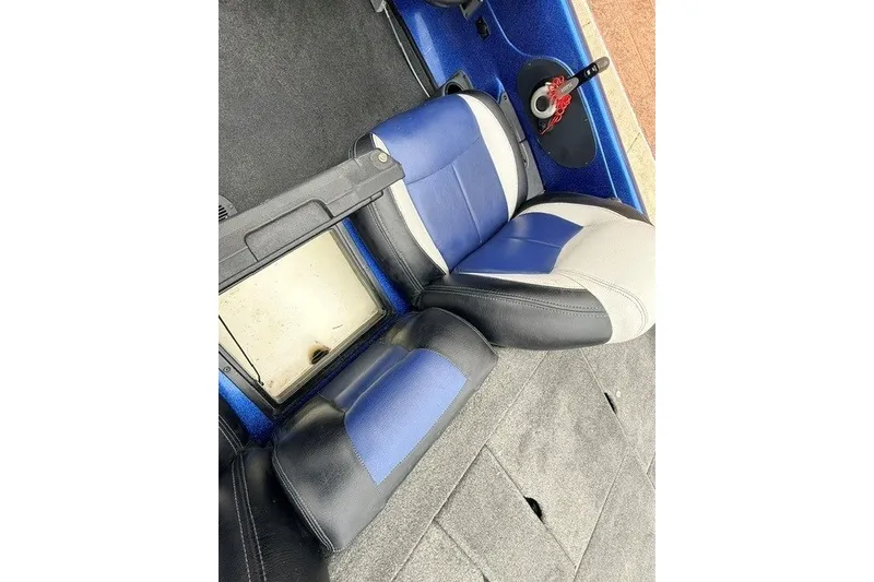 Slide: The Image of 2014 Skeeter TZX195 boat interior with blue and gray seating and storage compartments. - 19