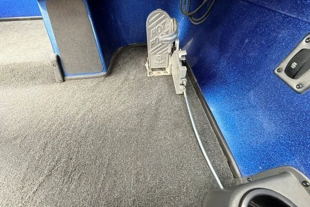 Slide: The Image of Foot pedal in a 2014 Skeeter TZX195 boat interior, blue and gray design. - 20