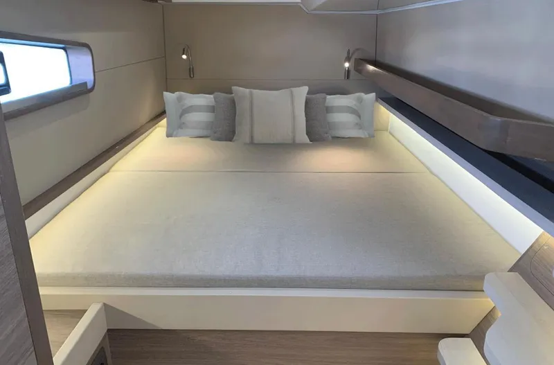 Slide: The Image of 2025 Aventura 38 Sport Coupe interior cabin with modern bedding and ambient lighting. - 16
