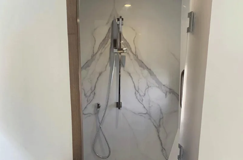 Slide: The Image of Modern shower in 2025 Aventura 38 Sport Coupe with marble-style wall design. - 22