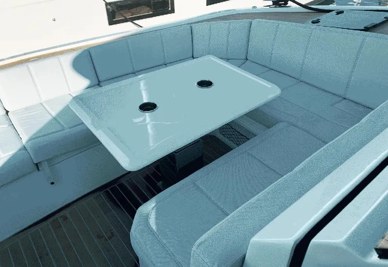 Slide: The Image of 2025 Aventura 38 Sport Coupe interior with sleek seating and modern table design. - 20