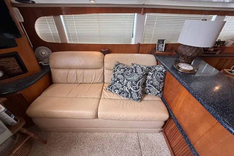 Slide: The Image of Luxurious interior of 2000 Carver 396 Motor Yacht with leather seating and decorative pillows. - 19