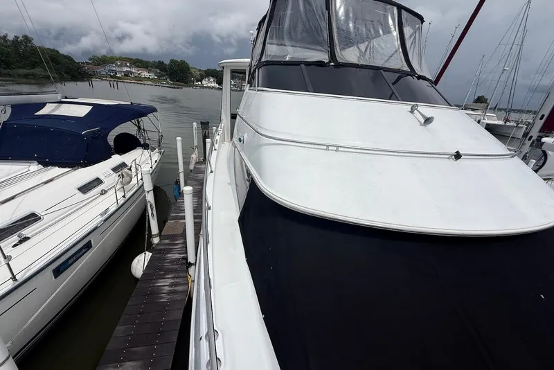 Slide: The Image of 2000 Carver 396 Motor Yacht docked beside another boat on a cloudy day. - 10