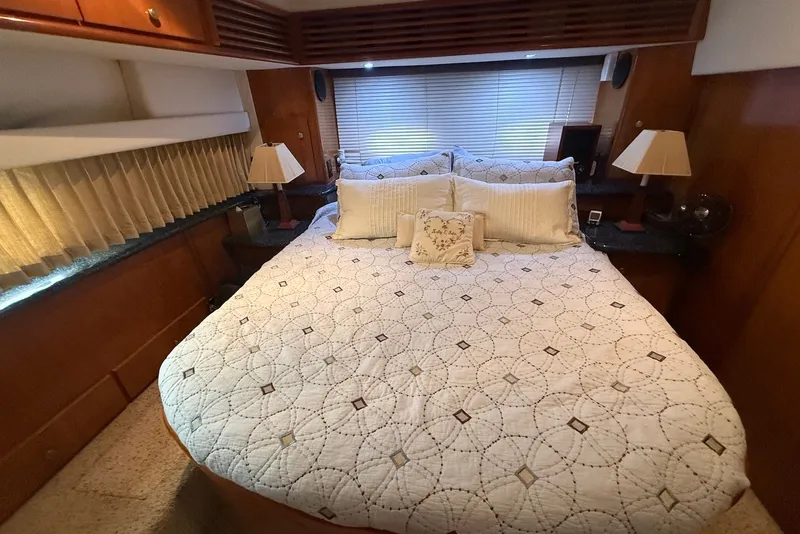 Slide: The Image of Luxurious bedroom interior of 2000 Carver 396 Motor Yacht with elegant bedding and lamps. - 28