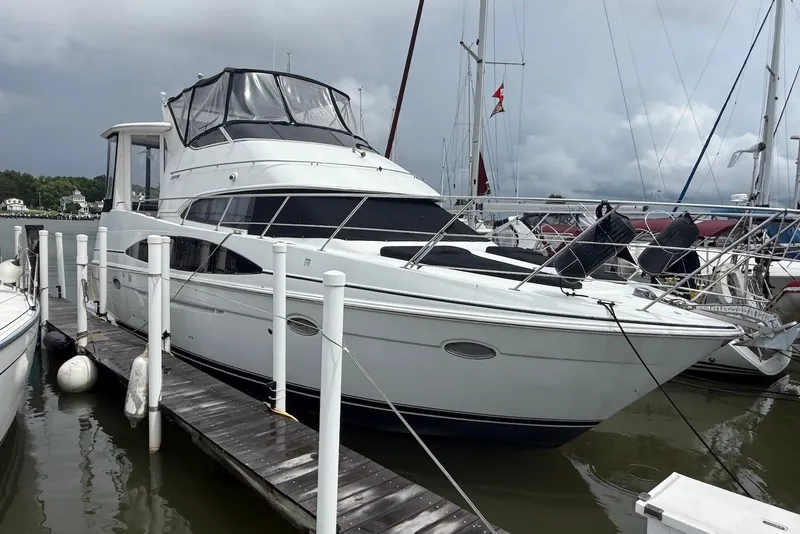 Slide: The Image of 2000 Carver 396 Motor Yacht docked at marina under cloudy skies. - 1
