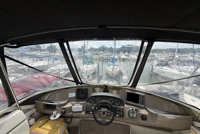Slide: The Image of Interior view of 2000 Carver 396 Motor Yacht helm at marina. - 15