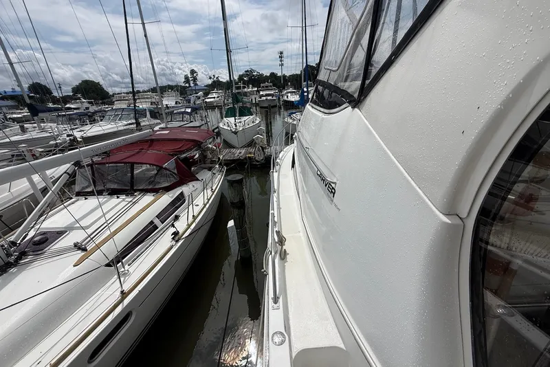 Slide: The Image of Carver 396 Motor Yacht 2000 docked among sailboats in a marina. - 7