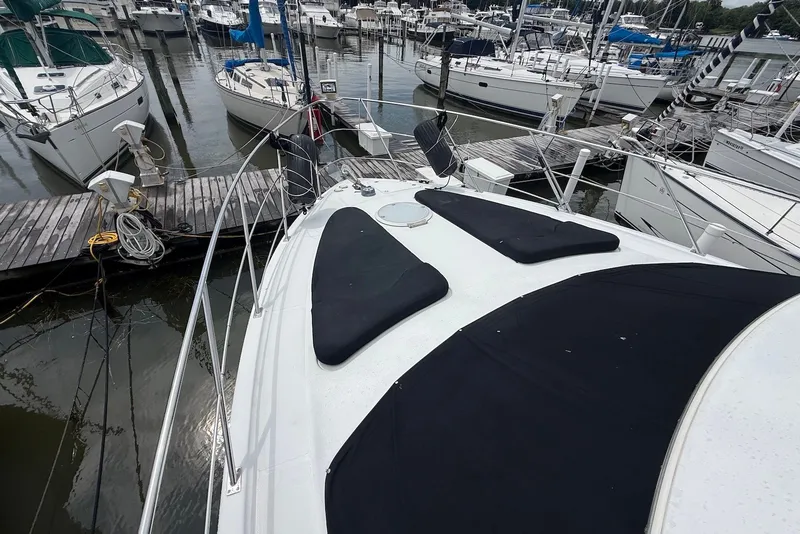 Slide: The Image of 2000 Carver 396 Motor Yacht docked at marina with other boats. - 8