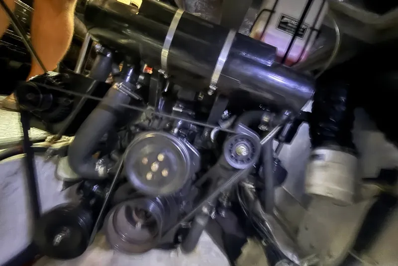 Slide: The Image of Engine compartment of a 2000 Carver 396 Motor Yacht, showcasing mechanical components. - 33