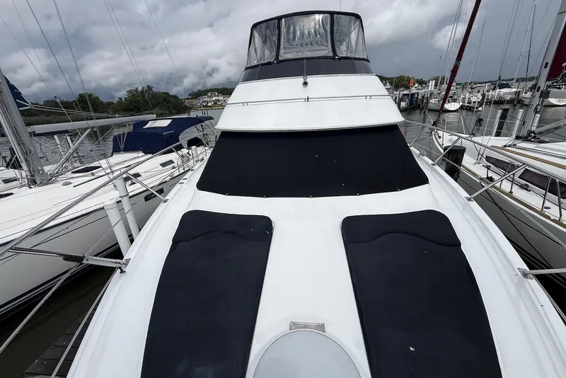 Slide: The Image of 2000 Carver 396 Motor Yacht docked at marina under cloudy skies. - 9
